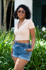 black women outside wearing a tan Ribbed Collar Crop Top and high waist denim shorts and brown square sunglasses